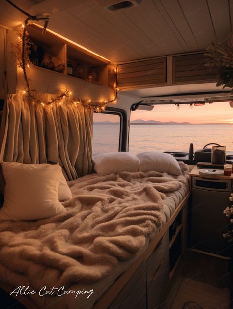 Image shows the inside of a cozy, well-lit van at sunset. The interior has a warm beige aesthetic with decorative fairy lights adding a soft glow. Outside the van, a beautiful, tranquil sunset can be seen through the open door, creating an inviting, serene atmosphere suggestive of a peaceful van life. Van Life Diy, Van Interior, Road Trip Adventure, Van Life, Fairy Lights, Caravan, Road Trip, Camping, Road