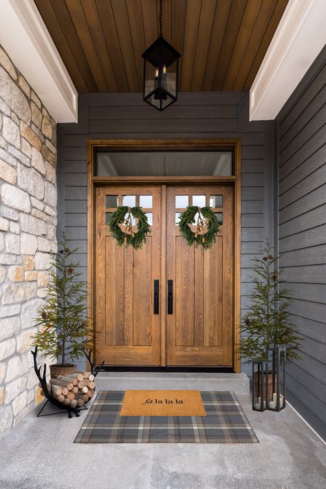 Holiday front porch idea with a christmas door mat, antler wood holder and wreaths on the door by Liz Powell Design. simple chrismtas porch ideas #lizpowelldesign #holidaydoor #christmasfrontporch #homedecor #holidaymat #doubledoor #modernfarmhouse Cedar Entryway Front Porches, Double Door Christmas Decor, Holiday Front Porch, Christmas Door Mat, Double Door Entryway, Double Doors Exterior, Cedar Posts, Quonset Hut, Front Door Christmas Decorations