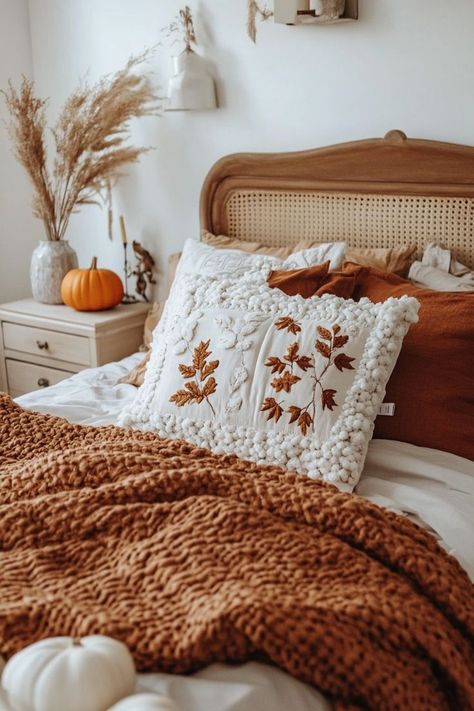 Cozy Up with Autumn-Inspired Bedding 🍁 Cozy bedroom with autumn-themed decor, orange blanket, leaf-embroidered pillow, and a pumpkin on the nightstand. | Sky Rye Design Fall Bedding Bedrooms, Cottage Nightstand, Autumn Bed, Cozy Bedding Ideas, Fall Patio Decor, Bedding Cozy, College Core, Fall Patio, Orange Blanket