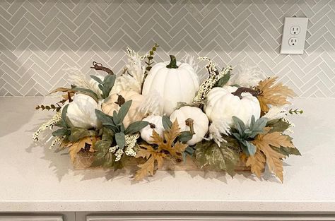 Beautiful large fall arrangement filled with white pumpkins, pampas grass, berries, sage, fall leaves and berries nestled in a wood tray. This custom piece adds a touch of fall to any room in your home. Also makes a great gift. Overall dimensions 22" long x 12" wide x 11" tall. Pumpkin Table Display, Diy Dough Bowl Centerpiece, Fall Flower Arrangements For Home, Fall Tablescapes Farmhouse, Fall Decor Coffee Table, White Fall Decor, White Pumpkin Centerpieces, Pumpkin Flowers, Beautiful Bedroom Colors