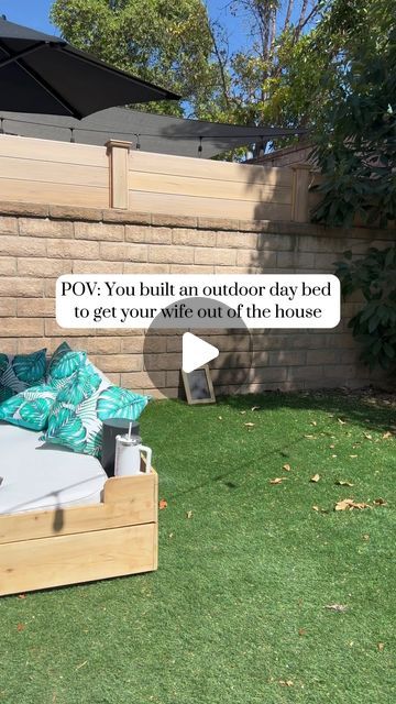 Trevor staley on Instagram: "My wife enjoys lounging in bed, thinking of new projects for me to do around the house. To help get her out of the house and get a little sun and vitamin D, I had the idea to build her an outdoor day bed. This day bed is smaller than a typical bed but unique because it has wheels to help roll it around the backyard. The center umbrella is also removable, incase she wants to try and tan in bed or for those outdoor movie nights. Although this build doesn’t come standard with a lip balm holder, it does have two cup holders for those giant drink cups she likes to sling around. What do you think? Would you lounge around on a day bed? #outdoorliving #diy #homedecor #backyard" Deck Day Bed Ideas, Garden Day Bed Ideas, Diy Outdoor Bed Lounge, Outdoor Pallet Lounge Bed, Round Patio Day Bed, Tv Room Design, Outdoor Deco, Lip Balm Holder, Outdoor Daybed