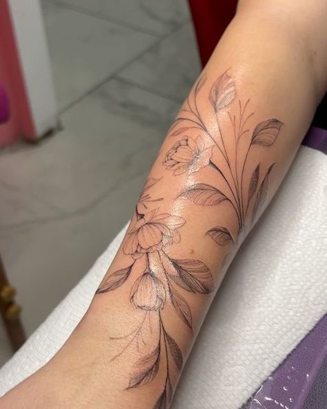 Dainty Leg Sleeve Tattoo, Flower Vein Tattoo, Peony Vine Tattoo, Magnolia Wrap Around Tattoo, Dainty Flower Vine Tattoo, Flowers On Vines Tattoo, Birth Flower Vine Tattoos, Wraparound Tattoo Forearm, Tattoos That Wrap Around Arm