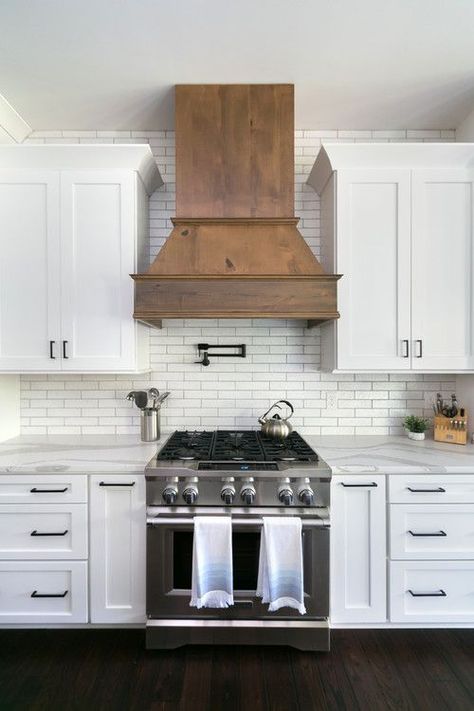 White and Wood Modern Farmhouse Kitchen with White Cabinets and Wood Range Hood #kitchen #kitchendecor #kitchendecorideas #kitchendecorating #kitchendecoratingideas #farmhousekitchen #modernfarmhousekitchen #whitekitchens #modernfarmhouse #farmhouse #farmhousedecor Pipe Shelving, White Cupboards, Wood Range Hood, Modern Farmhouse Kitchen, Farmhouse Kitchen Cabinets, Investment Properties, New Kitchen Cabinets, Kitchen Hoods, Classic Kitchen