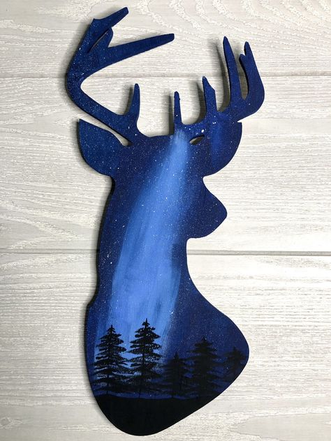 "Do you love nature and the outdoors? This hand-painted deer head wall art with night sky silhouettes is the perfect addition to your nature decor. Whether you're an animal lover like me or an avid hunter, this is a great reminder of the outdoors. The beautiful pine tree silhouettes pop against the starry night sky. Each deer wall art is hand-painted and may vary slightly from what is shown. The deer wall art is approximately 8\"x15\". Can't you just hear the crickets chirping, a gentle stream flowing while the wind whistles between the tall pines?" Deer Silhouette Painting, Crickets Chirping, Deer Head Decor, Painted Deer, Deer Head Silhouette, Pine Tree Silhouette, Deer Wall Art, Deer Silhouette, Silhouette Painting