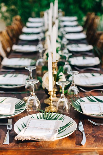 Fan palm leaf plate chargers bring a subtle tropical flair to a wedding tablescape set with rich wood and gilded candelabras, combining for refined rustic elegance. Tropical Wedding Theme, Tropical Wedding Decor, Palm Leaf Plates, Wedding Table Designs, Tulum Wedding, Destination Wedding Mexico, Leaf Plates, Hawaiian Wedding, Mexican Wedding