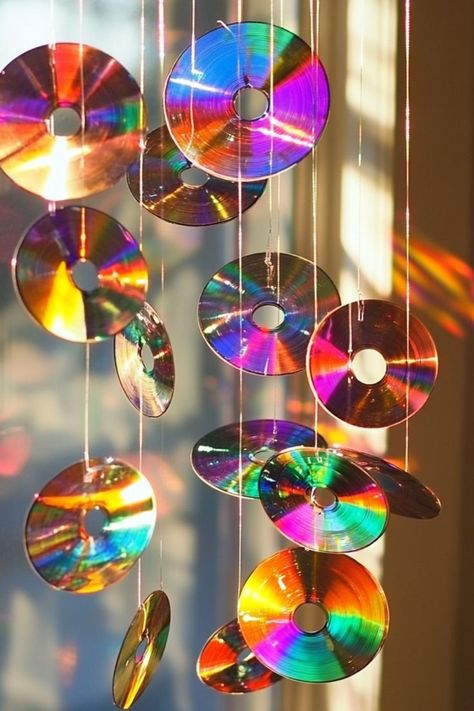 Create a beautiful DIY sun catcher with old CDs for a colorful, upcycled decor piece that catches light beautifully! #SunCatcher #UpcycledCrafts #EcoFriendlyDecor What To Make With Old Cds, Diy Old Cds Ideas, Crafts With Old Cds, Recycle Cds Ideas, Light Catchers Diy, Cd Diy Decoration, Diy Cd Crafts, Sun Catchers Diy How To Make, Cd Recycle Ideas