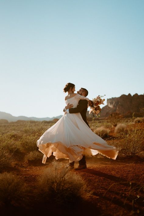 Fun & Creative Wedding Day Photo Poses and Ideas brides wears an off the should long flowy wedding dress. The groom holds her in his arms and spins her around letting her dress twirl perfectly. Wedding Photo Pauses, Spin Wedding Photo, Wedding Creative Photography Poses, Sweet Wedding Photo Ideas, Bride And Groom Twirl, Groom Spinning Bride, Whimsical Wedding Photoshoot, Rustic Wedding Photos Ideas, Wedding Dress Poses Photo Ideas