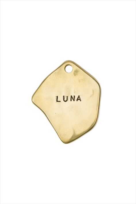 Our unique dog tags are perfect for pups, or a great way to easily identify your luggage. Made in Japan and designed in the USA in collaboration with Blink. This pet tag can be personalized with your pet's name and 1 or 2 phone numbers. Or you could prrrchase it without personalization and wear it as a charm. Tag size: W 1” x 1.1” (2.6 cm x 2.8 cm). Solid brass. Will change color with time and use. We provide a polishing pad with every order so you can make it sparkle again at any time. #dogtag Alex Proba, Dog Name Tags, Steel Frame Construction, Umbrella Designs, Ear Tag, Modern Pet, Dog Store, Dog Ear, Dog Id Tags