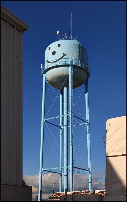 A blue water tower with a smiley face in the small town of Markle, Indiana. Wind Mills, Long Lost Friend, Water Towers, Scenic Wallpaper, Carnival Rides, Building Systems, Water Tower, Large Frames, Small Frame