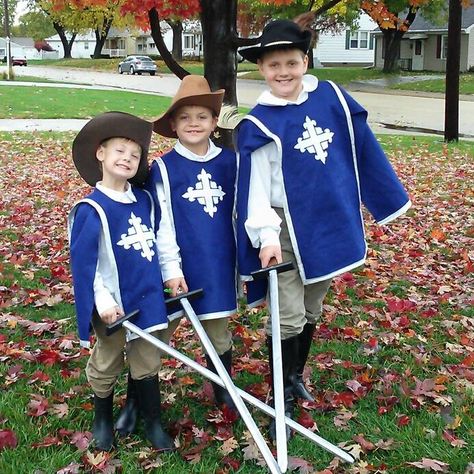 Three Musketeers. Literary Halloween costumes 1. Blue felt tunic 2. White felt cross. Google image, "musketeer cross" 3. Chinos, white dress shirts, and boots- Salvation Army thrift store. 4. Sew-ology double fold quilt binding bias tape, silver metallic. Hobby Lobby 4. Hobby Lobby feathers 3 Musketeers Theme Party, Three Musketeers Halloween Costume, 3 Musketeers Costume, Three Musketeers Costume, Musketeer Outfit, Literary Halloween Costumes, Musketeers Costume, Kids Book Character Costumes, Felt Cross