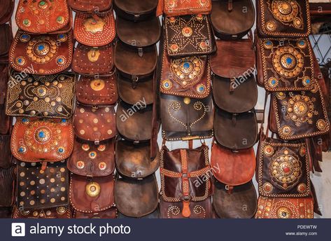 Download this stock image: Moroccan leather goods and bags with metal ornaments at a souk or market by the tannery in Fes, Morocco. - PDEWTW from Alamy's library of millions of high resolution stock photos, illustrations and vectors. Crafts From Around The World, Fes Morocco, Metal Ornaments, Leather Portfolio, Moroccan Leather, Ikat Fabric, Metal Ornament, Lace Making, Traditional Crafts