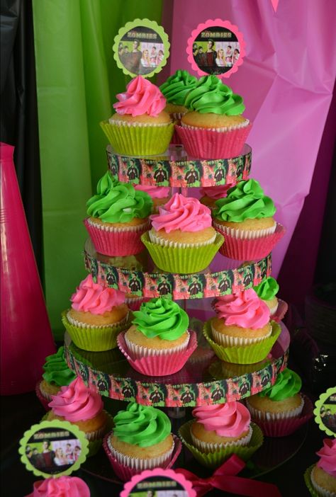 Disney Zombies Cupcakes by Me! Hotpink, Lime Green, Black. I used Disney Zombie ribbon as a border around the cupcake stand Zombies Cupcakes Disney, Zombies 3 Cupcakes, Seabrook Zombies Party, Zombie 3 Party Ideas, Disney Zombie Cupcakes, Disney Zombies 3 Birthday Party, Zombies Movie Party, Zombies 3 Birthday Party Cake, Disney Zombies Party Food