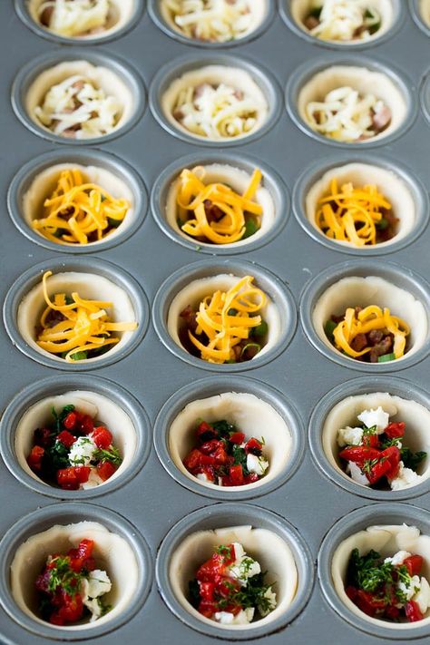 Muffin tins filled with pie crust, vegetables, meat and shredded cheese. Mini Quiche Filling Ideas, Mini Quiches In Muffin Tin With Crust, Mini Quiches In Muffin Tin Puff Pastry, Quiche In Muffin Tins, Individual Quiche Recipes, Mini Quiche Tarts, Mini Quiches In Muffin Tin, Minced Pie, Pie Crust Appetizers