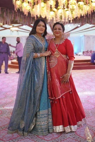 '24 | Patel family's son's wife with her mother-in-law flaunting in TASTA-designed blue & red silk lehenga choli adorned with tissue dupattas. Tissue Chaniya Choli, Chaniya Choli, Gowns Of Elegance, Timeless Beauty, Indian Fashion, Lehenga, Special Occasion, Textiles, Silk