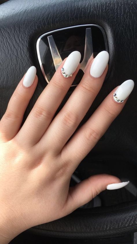 Perfect matte white almond acrylic nails with diamond stones / Pinterest @ShelbyHarms✨ #almondnails #whitenailpolish #nails All White Nails With Rhinestones, White Nails With Diamonds Rhinestones, White Nails With Crystals, Frosted White Nails, White Almond Acrylic, White Almond Acrylic Nails, White Nails With Gems, Almond Nails Medium, White Diamond Nails