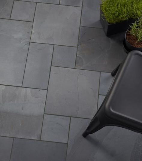 Outdoor patio paved with black slate Versailles patterned tile. A chair and plants are arranged on the patio. Black Slate Floor Tiles, Outdoor Patio Floor, Patio Floor Tiles, Tile Floor Patterns, Slate Floor Tile, Black Slate Floor, Outdoor Tiles Floor, Southern Colonial, Slate Tile Floor