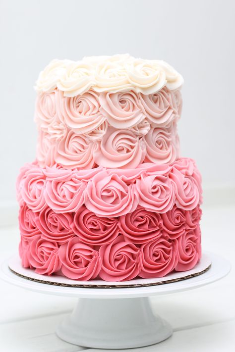 This is a 2 tier pink rose ombré cake covered in buttercream icing💗 Pink Rosette Cake 2 Tier, Pink Ombre Rosette Cake, Ombré Rosette Cake, Pink 2 Tier Birthday Cake, 2 Tier Rosette Cake, 2 Tier Pink Cake, Two Tier Pink Cake, Ombre Rose Cake, Pink Buttercream Cake