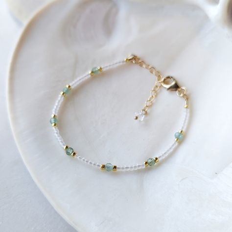 Like the clear teal waters of a tropical destination - this *rare* Aqua Teal Green Apatite bracelet is absolutely dreamy! The Aqua Teal Green Apatite gemstones have the most captivating transparent teal color to them. And they are not something you can find very often. They are paired with semi-transparent pearlescent glass beads for the ultimate beachy look! SHOP THE MATCHING NECKLACE! Just like water, Green Apatite has the power to purify, cleanse and calm. It is also an empowering stone of manifestation. It can give you greater inner strength, inspiration and clarity. It can help you tune in to your intuition, so that you can begin making decisions with confidence. Colors: This beaded bracelet features semi-transparent matte glass beads in the most alluring pearlescent white color Gemst