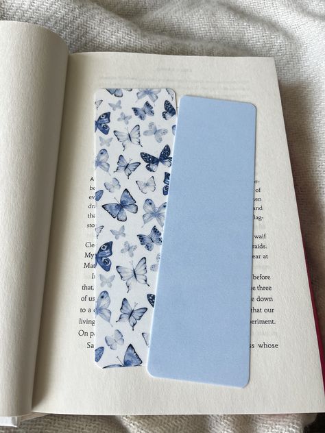 set of 2 blue + butterfly bookmarks! the patterned bookmark is a seamless pattern & may vary a little when printed. bookmarks are printed on thick cardstock & laminated on both sides to prevent tears! Blue Book Mark, Breaks Books, Printed Bookmarks, Aesthetic Bookmarks, Bookmarks Diy, Broken Book, Aesthetic Profile Picture Cartoon Soft, Handmade Bookmarks Diy, Watercolor Bookmarks