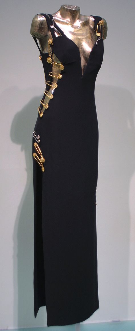 Evening gown worn by Elizabeth Hurley, Spring-Summer 1994, Versace, black viscose and acetate with kilt pin embellishments Versace Black Dress, Black Versace Dress, Vintage Versace Dress, Versace Aesthetic, Safety Pin Dress, Versace Safety Pin, Vestidos Versace, Versace Design, Pin Dress