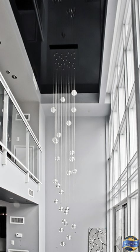 A gorgeous extra long chandelier and a high gloss black stretch ceiling do justice to this gorgeous modern double height passage. www.laqfoil.com/ Double Ceiling Chandelier, Minimalist Entrance Chandelier, Double Height Hanging Light, Double Height Chandelier Modern, Long Ceiling Light, Long Chandelier High Ceilings, Modern Chandeliers High Ceilings, Double Height Chandelier, Staircase Chandelier Contemporary