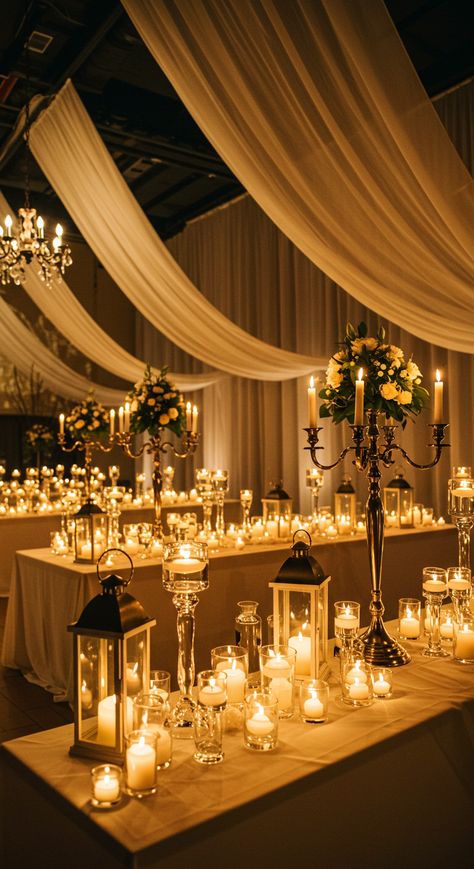 ✨ Experience the magic of romance at our wedding reception hall, beautifully illuminated by candlelight. 🕯️ Candelabras, hurricane lanterns, and votive candles in elegant glass holders set the scene. 🌟   Sheer white fabric gracefully drapes the walls, while warm, dim lighting creates a truly enchanting atmosphere. 💫 Perfect for your dream wedding! 💍💖 #WeddingMagic #CandlelitRomance Candle Centerpieces Elegant, Green Wedding Accents, Candlelit Wedding Reception, Best Wedding Decor, Olive Green Wedding, Outdoor Garden Party, Wedding Reception Hall, Olive Green Weddings, Rustic Wedding Table Decor