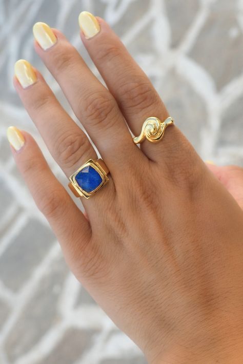 This Swirl Ring is crafted with intricate ancient Greek designs for a jewelry piece that's as eye-catching as it is timeless. Show off your unique style with this distinctive ring. Will you be next to rock this classic statement piece? INOOKU was established in 2016 and is based in central Athens. All INOOKU pieces are handmade, ethically and traditionally created with techniques inspired by the ancient Greeks. All pieces are handmade with attention to detail by highly skilled technicians, and t Greek Design, Lapis Ring, Lapis Blue, Swirl Ring, Greek Style, Right Hand Rings, Greek Jewelry, Ancient Greek, Fire Nails