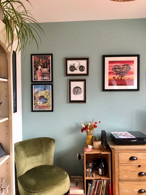 A living room corner, with an green chair and teal blue wall, covered in artwork. Dix Blue Farrow And Ball, Light Teal Walls, Farrow And Ball Dix Blue, Turqoise Bedroom, Light Teal Paint, Delhi House, Colourful Rooms, Farrow And Ball Living Room, Lounge Curtains