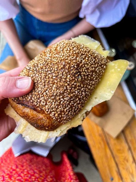 Do you love savory breakfasts? If so, this Danish morning bun topped with sesame seeds and filled with cheese will become your new favorite. Any Copenhagen city travel guide should include Hart Bageri, which bakes the best pastries in Copenhagen. || #morningbun #Danishbread #comté #cheese #sesameseeds #sourdough #bakery #pastries #Copenhagen #travelguide #weekendgetaway #itinerary #cityguide Bakery Pastries, Sourdough Bakery, Best Pastries, Savoury Breakfast, Morning Bun, Raspberry Bars, Cardamom Buns, Croissant Dough, Copenhagen City