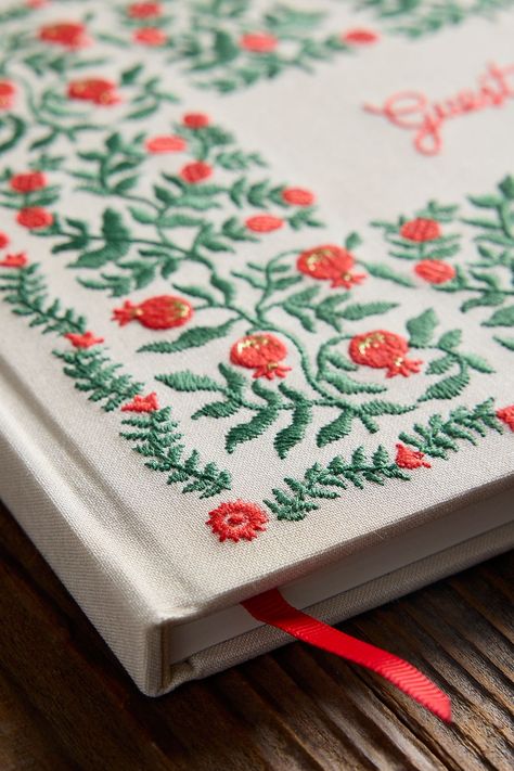 This large hardcover guestbook includes 144 pages, half lined and half blank so guests can write a note, add a sketch, or paste in a photo to create a one-of-a-kind keepsake. The cover is wrapped in book cloth and embroidered with pomegranates and a grosgrain ribbon bookmark will save your place. Embroidered Altar Cloth, Hand Painted Notebooks, Embroidery Book Cover, Cloth Bookmarks, Hand Embroidered Gifts, Embroidered Book, Creative Books, Embroidery Book, Embroidered Gifts