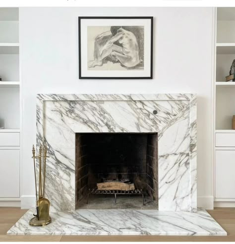 Gorgeous, clean marble framing the fireplace Marble Fireplace With Mantle, Marble Tile Around Fireplace, Marble Fireplace Surround Ideas, Brown Marble Fireplace, Marble Fireplace Wood Mantle, Electric Fireplace With Marble Surround, Marble Fireplace Ideas, Brown Marble Fireplace Surround, Marble Tile Fireplace