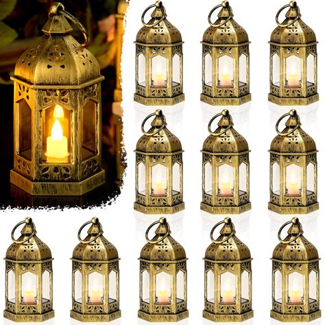 PRICES MAY VARY. Elegant Mini Lanterns: the vintage lanterns for wedding centerpieces are made of quality plastic and glass materials, sturdy and serviceable, safe and reliable, which measure approx. 4.92 x 2.56 inches/ 12.5 x 6.5 cm, small and mini in size without the ring; Please pull out the white insulation sheet before use to turn on flashing Exquisite Appearance: each of the hexagonal Moroccan style candle lantern decorations is designed with 6 pieces transparent glass sides, a small and e Hanging Wall Lanterns, Battery Lantern, Arabian Nights Party, Hanging Candle Lanterns, Hanging Candle, Mini Lanterns, Lantern Centerpieces, Lantern Candle Decor, Diwali Decor