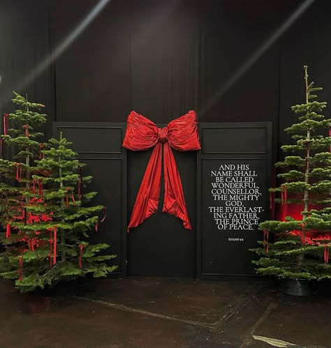 Our team created a breathtaking Christmas decor at the @ffministry church 🕯️ We crafted a magnificent, oversized red silk bow that… | Instagram Christmas Stage Decorations, Christmas Foyer, Merry Christmas To Everyone, True Christmas, Black Party Decorations, The True Meaning Of Christmas, Ward Christmas Party, Writing On The Wall, Church Christmas Decorations