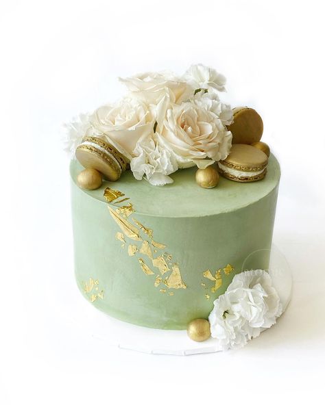 Sage green cake with Edible 24k Gold Leaf, Gold Macarons & Fresh White Flowers Sage Green Cake With Flowers, Sage Green Fondant Cake, Green Gold White Cake, Green Gold And White Wedding Cake, Green And Gold Birthday Cake For Women, Sage Green Gold And White Party, Sage And Gold Birthday Party, Sage Green Sheet Cake, Sage Green Cake Aesthetic