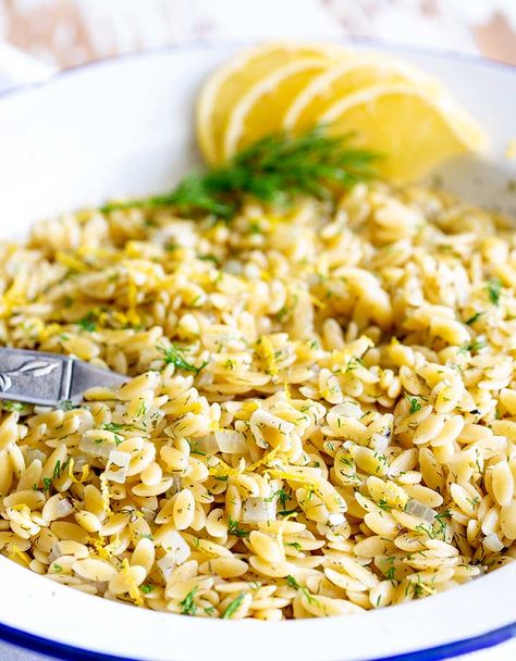 This Greek Orzo with Lemon and Herbs makes the best side dish for fish or chicken. It is quick to cook and packed with flavor. In under 15 minutes, you can have this fresh and delicious pasta side dish ready for the table. I find that kids love the little pasta too! You can serve it hot or cold and it tastes wonderful the next day, making it great for lunchboxes. #greekfood #easysidedish #quickpasta #pastasidedish Greek Lemon Orzo, Greek Orzo, Orzo Recipes Side, Greek Lemon Chicken, Lemon Orzo, Orzo Recipe, Side Dishes For Fish, Greek Food, Orzo Recipes