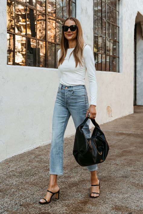 Fashion Jackson Wearing Express White Long Sleeve Bodysuit Express Jeans Black Pouch Handbag Black Heeled Sandals Street Style Bodysuit And Jeans Outfits, White Bodysuit Outfit, Outfits Ripped Jeans, Jeans Outfits Winter, Outfits With Sandals, Jeans Outfits Summer, Boyfriend Jeans Outfits, December Instagram, Light Wash Jeans Outfit