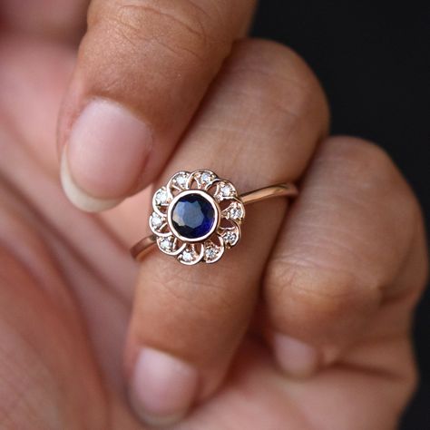 "This gorgeous vintage inspired flower ring with a 5mm natural blue Sapphire centre is a beautiful trip down memory lane. Natural Diamonds in the halo petals and crafted in 14k solid gold, the filigree lace gives it an Art Nouveau touch. A unique proposal ring which will make a perfect heirloom! * Gold : 14k / 18k Solid Gold * Gold Color : Yellow / Rose / White * Gold Wt. : ~ 3 gm (14kt) * Centre Gemstone : Natural Blue Sapphire (heated) * Sapphire Size : ~5mm * Halo Gemstone : Natural Diamonds Vintage Sapphire Engagement Rings, Vintage Gemstone Rings, Jewelry Queen, Sapphire Jewellery, Kyanite Ring, Sapphire Diamond Engagement, Vintage Engagement Rings Sapphire, Floral Filigree, Baby Rings