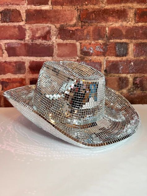 A silver cowboy hat sitting on top of a white table Disco Ball Boots, Beyonce Disco, Doralee Rhodes, Sparkly Cowgirl Hat, Disco Ball Hat, Cowboy Hat Disco Ball, Beyonce Bachelorette, Disco Tiles, Disco Cowboy Hat