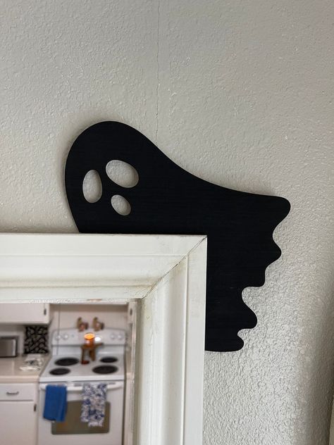 "Get ready for Halloween vibes with this charming custom wood corner silhouette for your doors! This ghost wood sign will elevate your Fall and Halloween decor. With this exquisite door corner accent crafted from plywood, delicately laser-cut to a sleek 1/8 inch thickness and elegantly lacquered in black, your Halloween decor is sure to be the envy of the neighborhood. Embrace the spirit of the season by adding this unique ghost decor to your doors, pictures, wall hangings, and more - we've painted both sides for your creative freedom. Crafted with care by our tight-knit family business nestled in Texas, each custom wood sign is a testament to our dedication. 💖 Delve into the Details: - Material: Laser-cut plywood - Dimensions: 8.25\" wide X 8.25\" tall Each piece will be slightly differe Diy Halloween Wood Cutouts, Laser Fall Decor, Halloween Cnc Project, Halloween Cnc Ideas, Cnc Halloween Projects, Seasonal Wood Crafts, Wooden Halloween Decor, Laser Cut Halloween Decor, Diy Wooden Halloween Decorations