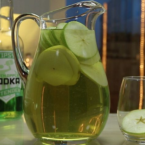 Bust out with this Green Apple Sangria at your next party and everybody will love you — or at least they'll love the sangria. This awesome wine cocktail combines apple vodka, Sour Apple Pucker, wine, white grape juice, apples, and pears, and tastes like a little green dream. Green Apple Mixed Drinks, Green Apple Vodka Drinks Recipes, Olive Garden Green Apple Moscato Sangria, Green Apple Vodka Cocktails, Green Apple Sangria, Vodka Sangria, Green Apple Vodka, Sour Apple Pucker, Sangria Drink