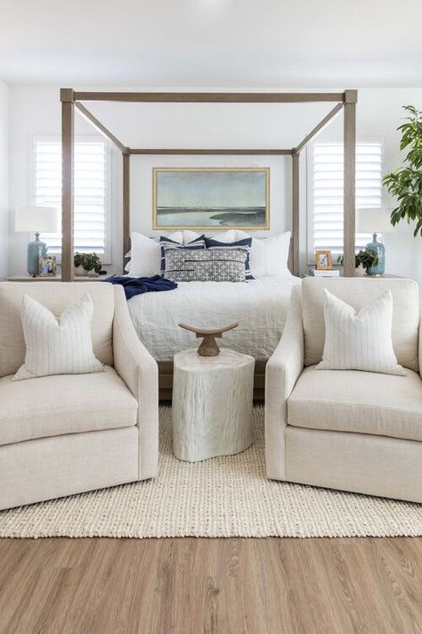 One of my favorite bedrooms! I love the light wood elements in the canopy bed and flooring, as well as the beautiful seating area with swivel chairs -- such a wonderful way to make the master suite feel more comfortable and inviting! bedroom ideas - master bedroom ideas - bedroom decor - bedroom furniture - bedroom design - modern coastal decor - modern bedroom ideas Salt Interiors, Modern Coastal Bedroom, Modern Guest Bedroom, Tattoo Modern, Wood Canopy Bed, Cozy Bedroom Design, Bedroom Seating Area, Bedroom With Sitting Area, Pure Salt