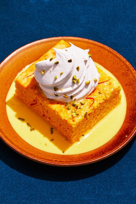 A truly luxurious bake that feeds a crowd, this pudding-y cake resembles tres leches except the milk soak is infused with floral, earthy saffron. The sponge cake is light and airy enough that it can drink up the sweet and creamy milk mixture without a long soak time. While just an hour of soaking will do the trick, the dessert tastes best cool, so aim for 4 hours in the fridge. Serve with a generous dollop of whipped cream and a sprinkle of pistachios for crunch and color. Saffron Milk Cake, Study Blue, Milk Cake Recipe, Saffron Milk, Saffron Cake, Thanksgiving Food Desserts, Tres Leches Cake, Milk Cake, Color Study