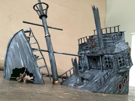 Pirate House Halloween, Diy Sunken Ship Under The Sea, Pirate Stage Design, Cardboard Shipwreck, Sinking Pirate Ship, Cardboard Pirate Ship Diy, Wrecked Pirate Ship, Shipwreck Decor, Pirate Ship Wreck