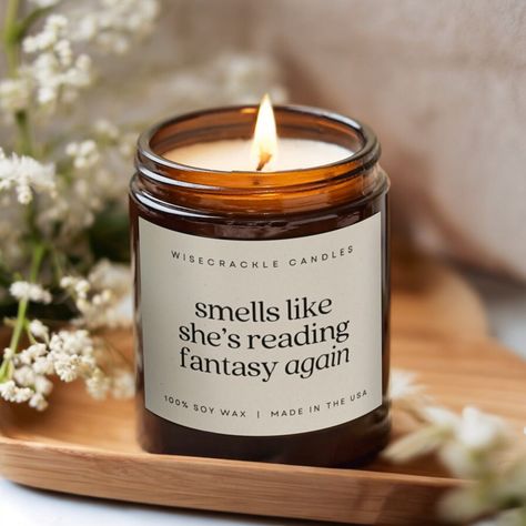 Perfect for the avid reader in your life, this "smells like she's reading fantasy again" candle makes an ideal gift for a reading girlfriend, bookish sister, or any book lover. Inspired by fantasy romance, this book-themed candle is a great addition to Bookstagram, BookTok, and book club gifts, bringing book humor and book lover decor to any space. Crafted with love, our candles feature 100% natural soy wax and a cotton wick in a reusable amber glass jar. Eco-friendly and free from lead, plastics, parabens, synthetic dyes, or phthalates, they provide a pure and uplifting experience. Choose from five delightful scents: - Cinnamon Vanilla - spicy cinnamon paired with sweet and creamy vanilla. - White Sage + Lavender - calming lavender with herbal sage and woody base. - Coconut Cream + Cardam Book Lover Decor, Bookish Candle, Bookish Candles, Book Candles, Book Club Gifts, Candle Reading, Candle Quotes, Bookclub Gifts, Amber Glass Jars