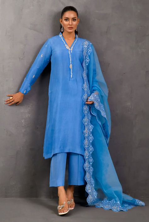 This splendid blue ensemble is fabricated on raw silk embellished with alluring sequins, pearls and French knots work giving this piece a perfect oomph. Paired with a gorgeous dupatta adorned with floral work. Colour: Blue Fabric: Shirt: Pure Raw Silk Pants: Pure Raw Silk Size: Model Is Wearing Size X-Small Dispatch Time: 3 to 4 weeks from Order Confirmation Disclaimer: Please note that the actual product and colors may appear different from the images displayed, as variations can occur based on Pakistani Designer Dress, Raw Silk Pants, Luxury Pret, Floral Work, French Knots, Order Confirmation, Luxurious Fabric, Silk Pants, Designer Dress