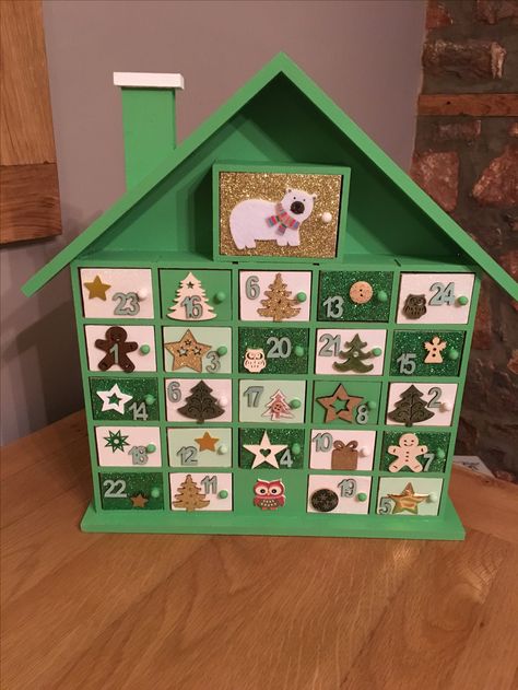 Hand painted Advent Calender. I started with a blank Calendar bought from Hobbycraft and decided to paint it green and white as it was for a boy, I’m really pleased how it turned out 😊 Painted Advent Calendar Ideas, Paint Your Own Advent Calendar, Hand Painted Advent Calendar, Painted Advent Calendar, Painted Wooden Advent Calendar, Wooden Painted Advent Calendar, Hobbycraft Advent Calendar, Handmade Advent Calendar Wooden, Wooden Advent Calendar House