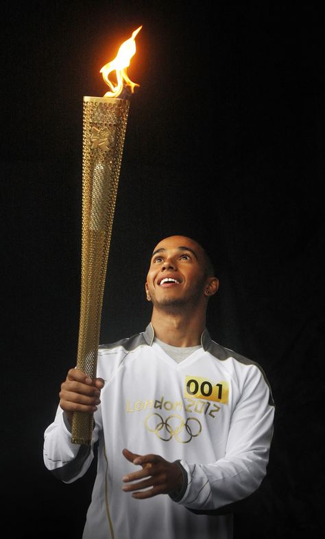 Formula One driver Lewis Hamilton poses for a photograph with the Olympic Flame before his London 2012 Olympic Games torch relay through Luton, in southern England Olympic Flame, F1 Lewis Hamilton, Southern England, 2012 Olympics, Olympic Torch, Paris Summer, Sports Stars, Sports Photos, Summer Olympics