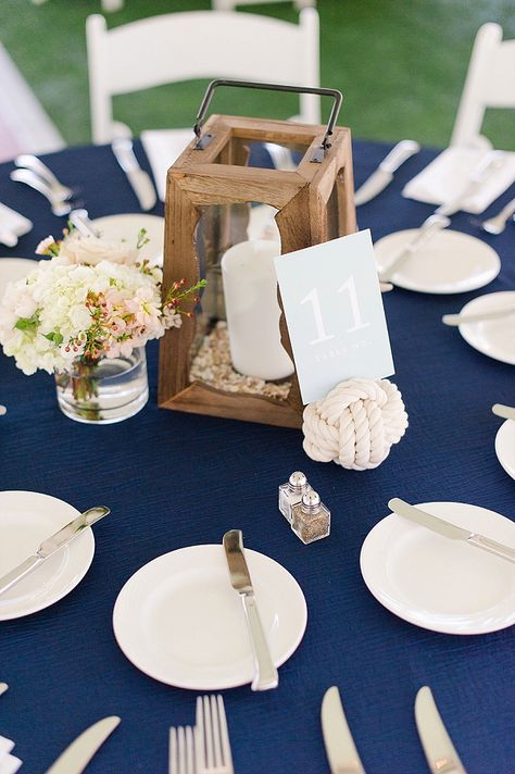 Nautical wedding centerpiece with monkey knot and wooden lantern Nautical Lantern Centerpiece, Coastal Fall Wedding, Nautical Centerpieces, Nautical Wedding Centerpieces, Monkey Knot, Nautical Centerpiece, Classic Blue Wedding, Coastal Virginia, Sailing Theme