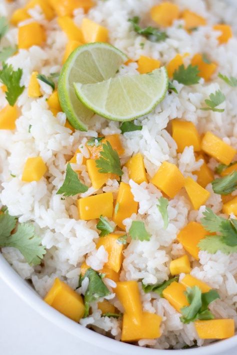 Fragrant fluffy jasmine rice cooked in coconut milk and garnished with diced mangos, chopped cilantro, and lime juice. Say goodbye to plain boring rice forever! Coconut-Mango Rice is a perfect side for tacos, chicken, fish, or pork dishes. You'll love it with my recipe for Blackened Tilapia! Honestly I have to say that after eating Coconut-Mango Rice, rice to me has never be the same. This recipe is a culinary game changer! Jasmine or Basmati rice are so fragrant when made with just… Coconut Mango Rice, Fluffy Jasmine Rice, Sides With Tacos, Bbq Foods, Mango Rice, Rice Side Dish Recipes, Rice Side, Dish Ideas, Rice Side Dishes