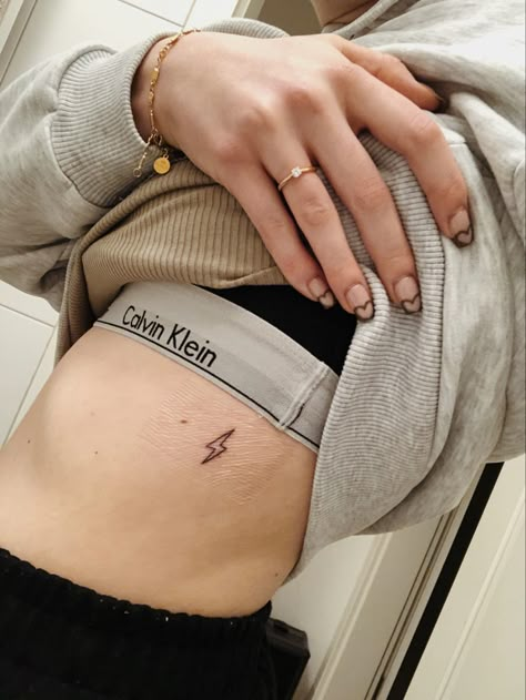 Lightning Bolt Rib Tattoo, Lightning Bolt Tattoo Rib Cage, Runner Tattoo For Women, Thunderbolt Tattoo, Runner Tattoo, Lightning Bolt Tattoo, Biblical Tattoos, Lightning Tattoo, Bolt Tattoo